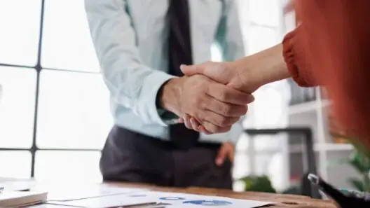 Two business people shake hands