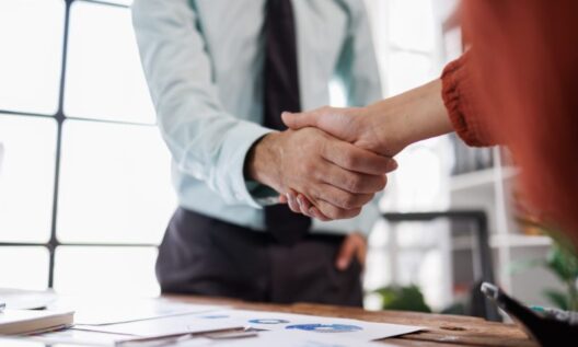 Two business people shake hands
