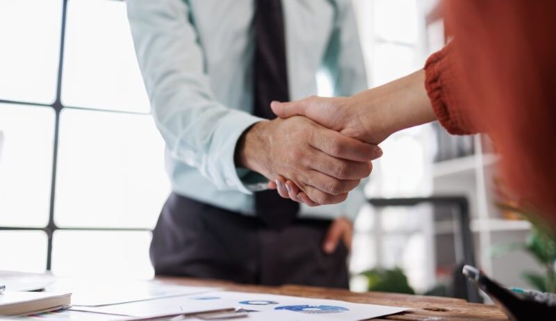 Two business people shake hands